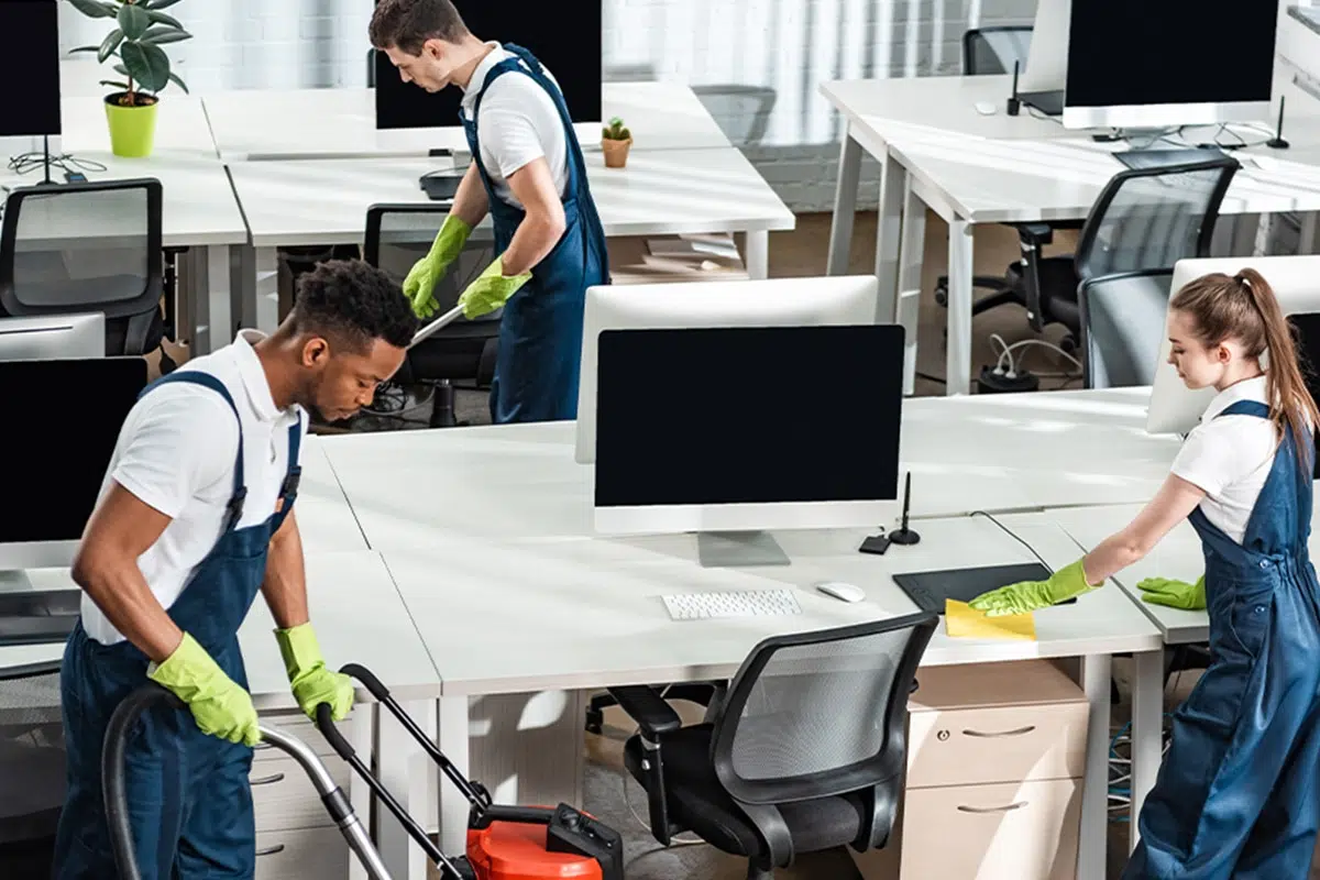 Office cleaning crew disinfecting desks and workspaces in Raleigh