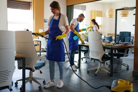 Office cleaning professionals disinfecting workspace in Raleigh NC
